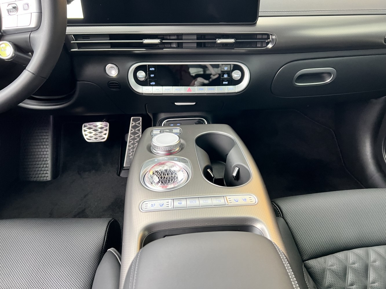 Modern center console and dashboard with rotary gear selector and digital controls