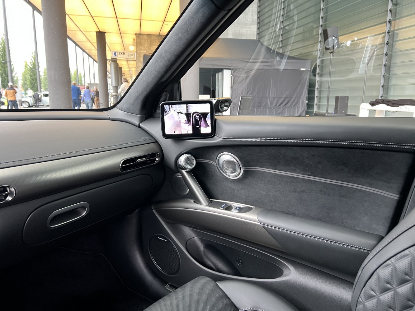 Modern interior door panel with digital side mirror display and premium materials