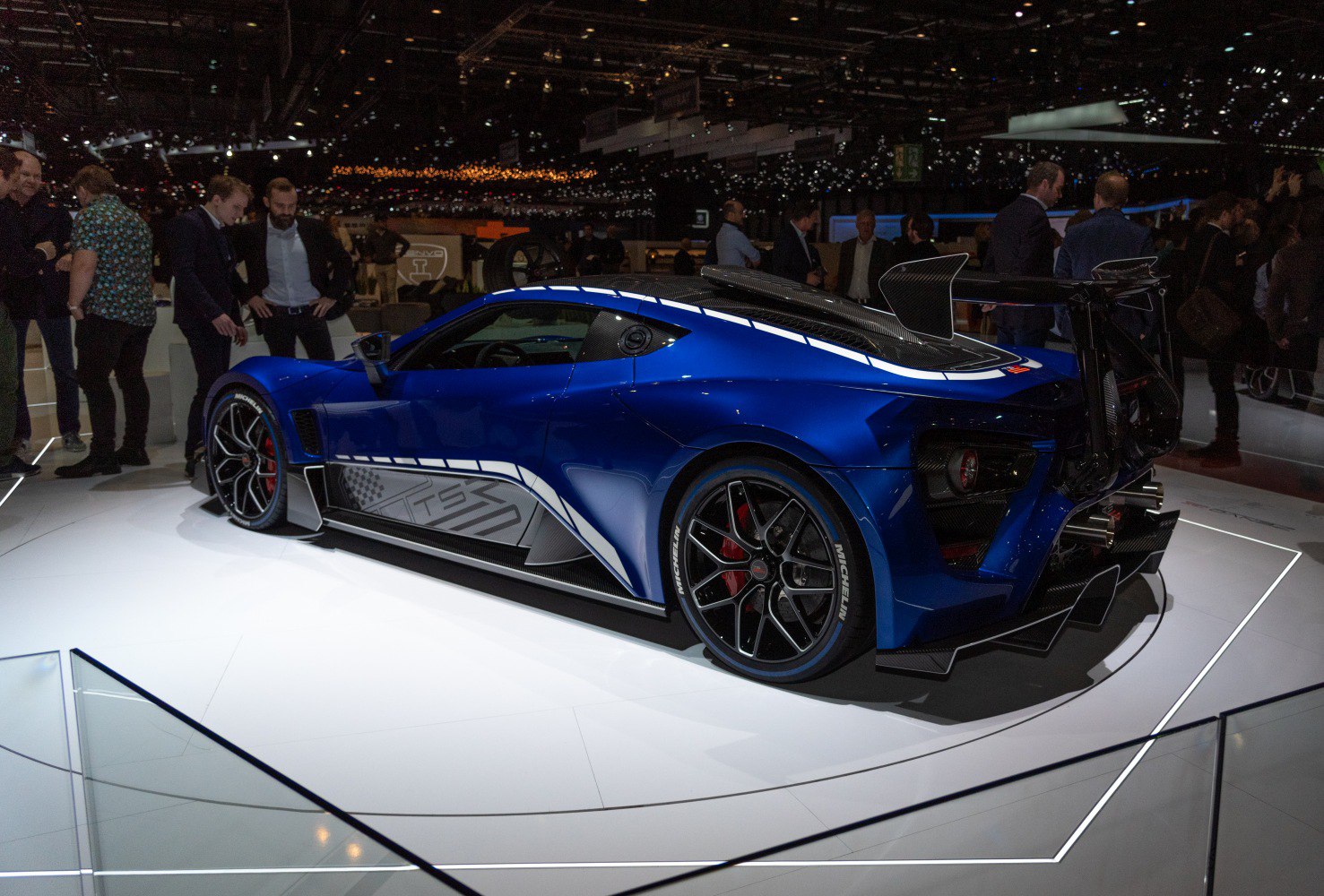 Blue sports car with aerodynamic body and oversized rear wing spoiler