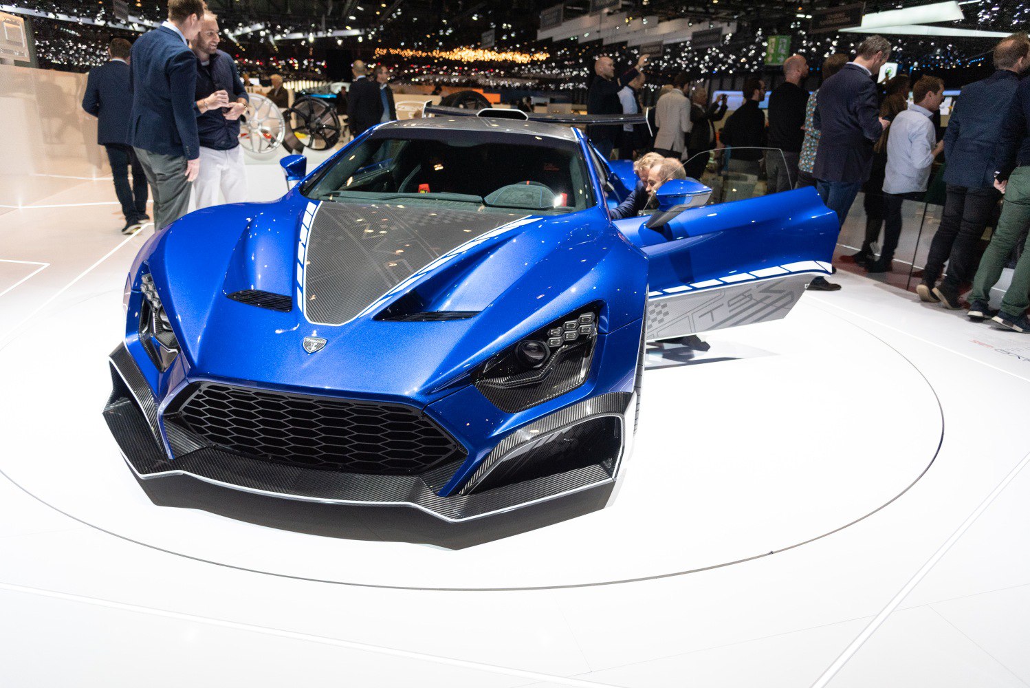 Aggressive front design with prominent grille, headlight cluster, and open side door