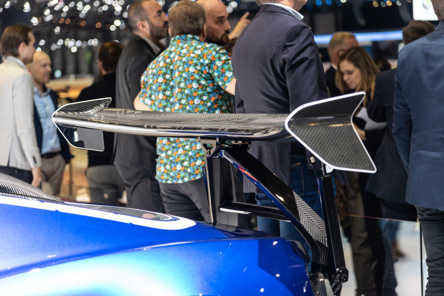 Carbon fiber rear wing spoiler mounted on a sports car