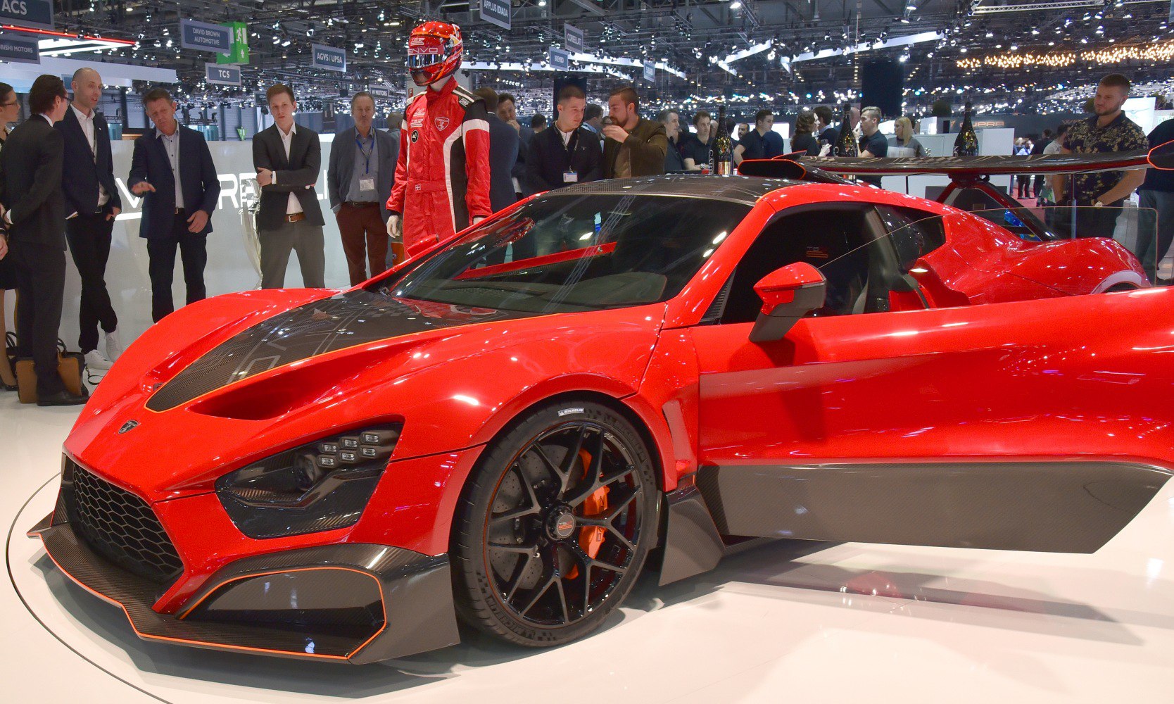 Red hypercar with aggressive aerodynamic design and carbon fiber elements