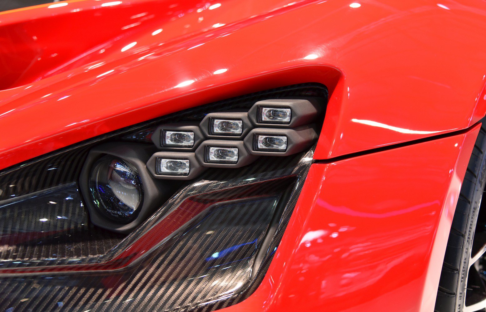 Close-up of multi-unit headlight and carbon fiber trim
