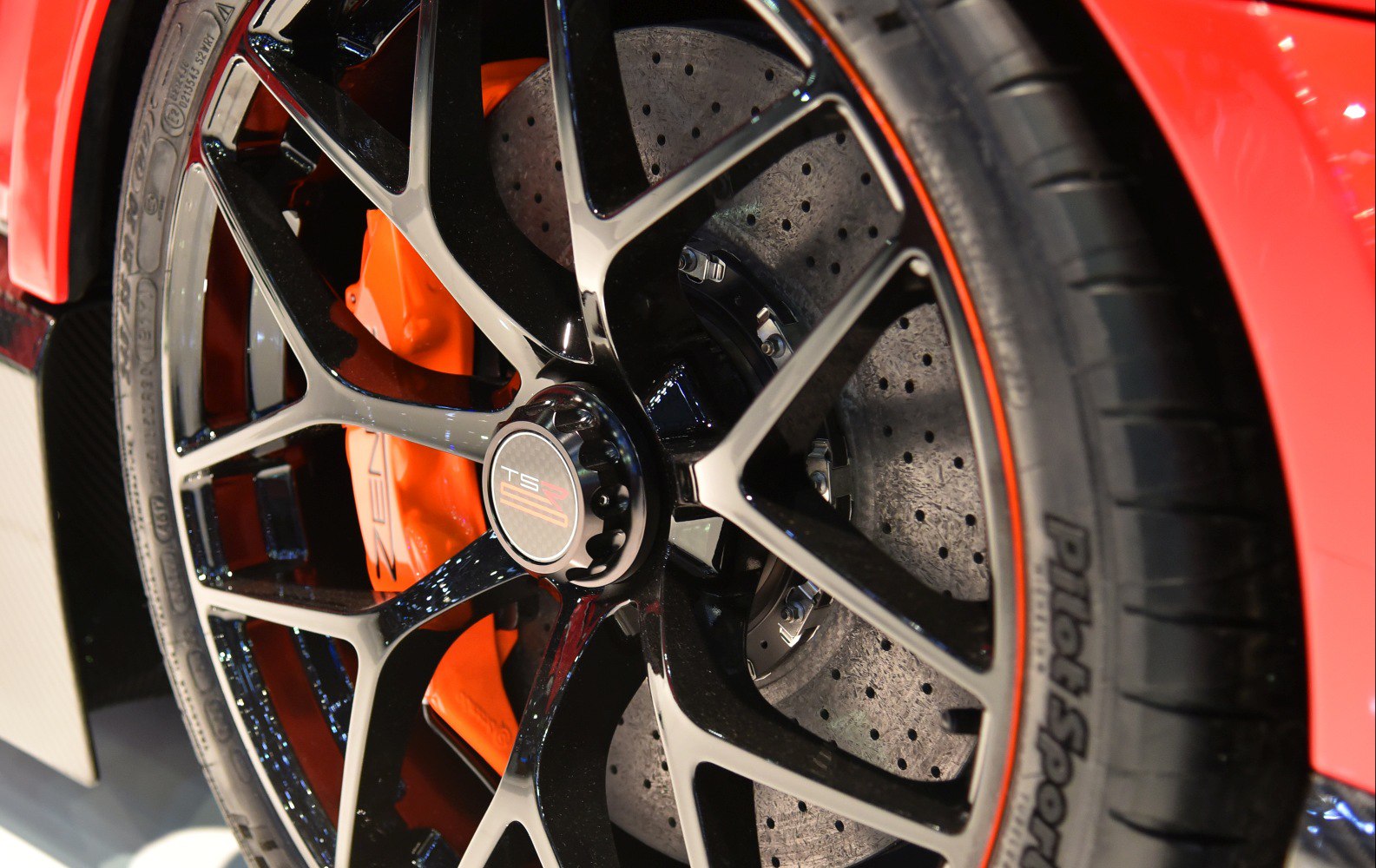 Black alloy wheel with orange carbon ceramic brake caliper