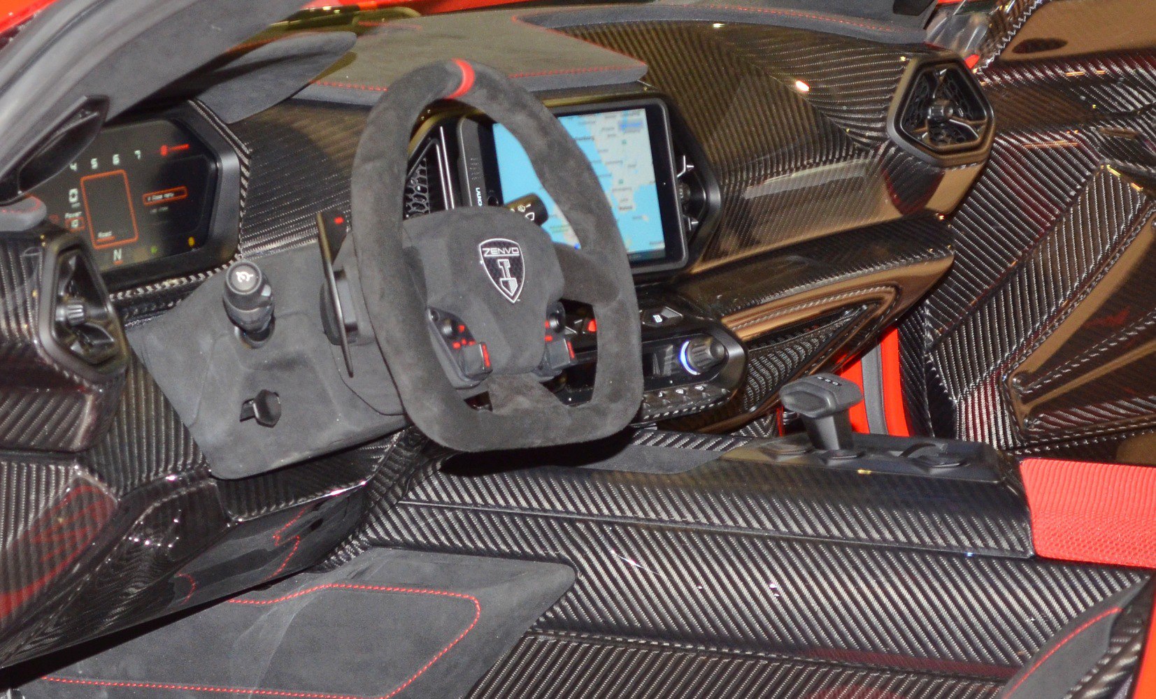 Carbon fiber dashboard and racing-style steering wheel in sports car interior