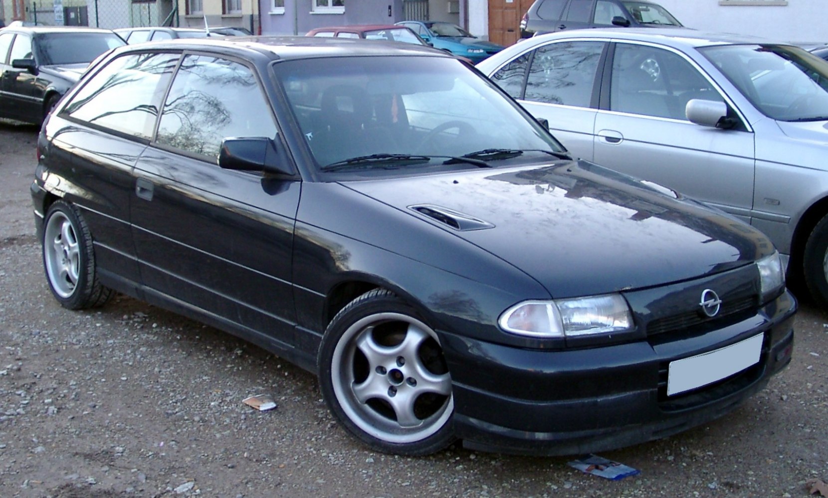 3-door hatchback with five-spoke alloy wheels and distinctive headlights