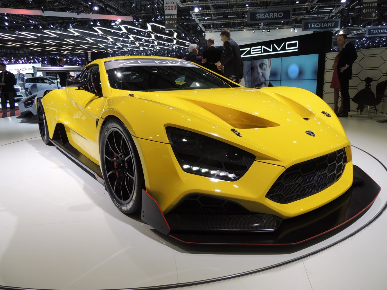 Aggressive aerodynamic front and unique headlights of a yellow sports car