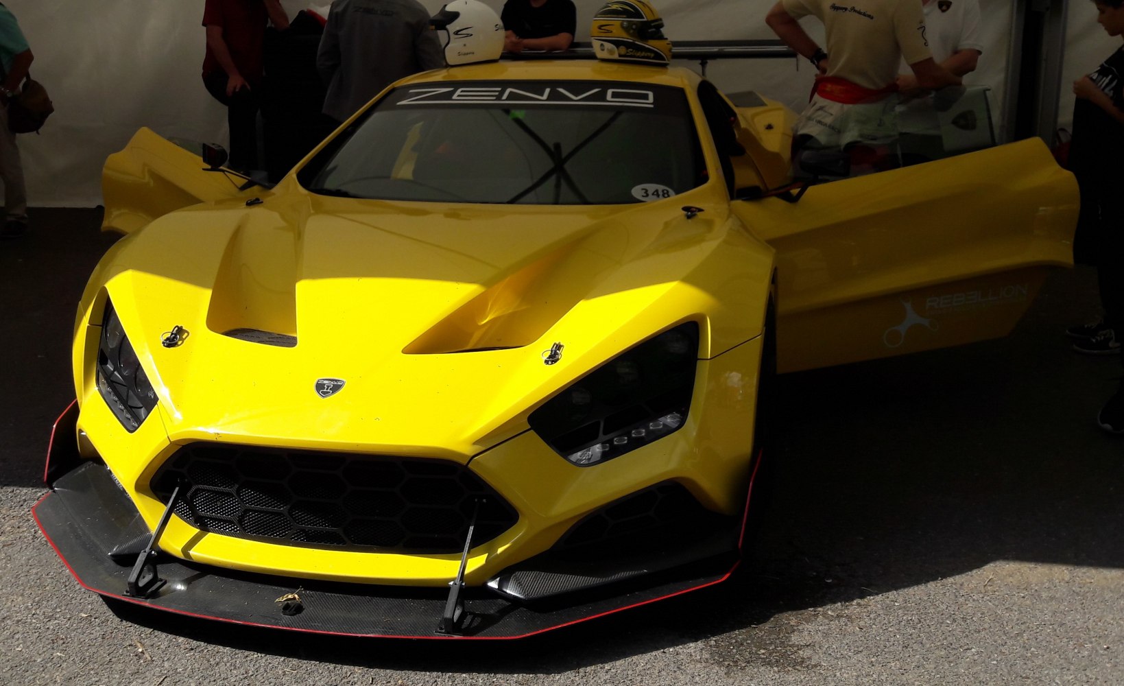Yellow race car front with aerodynamic details and open doors