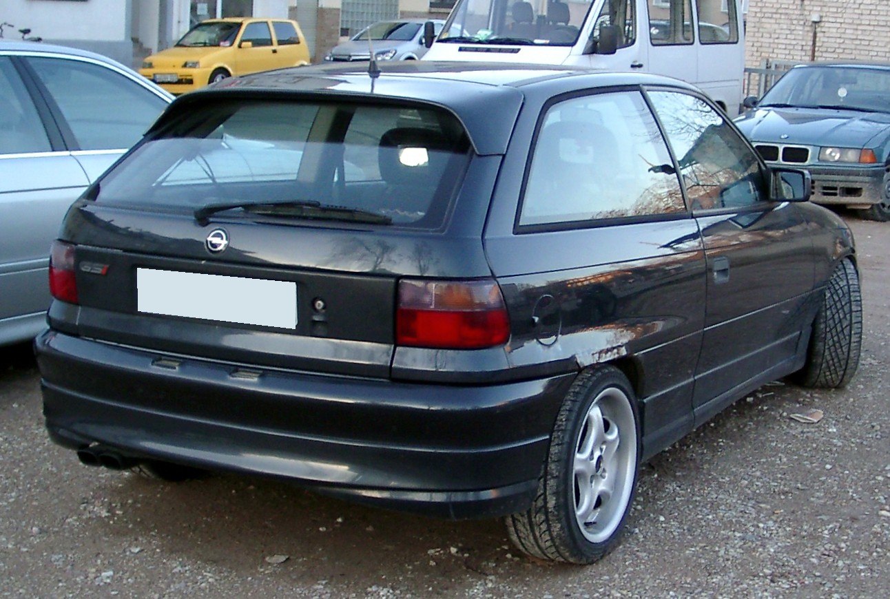 Rear hatchback view with taillights and alloy wheels