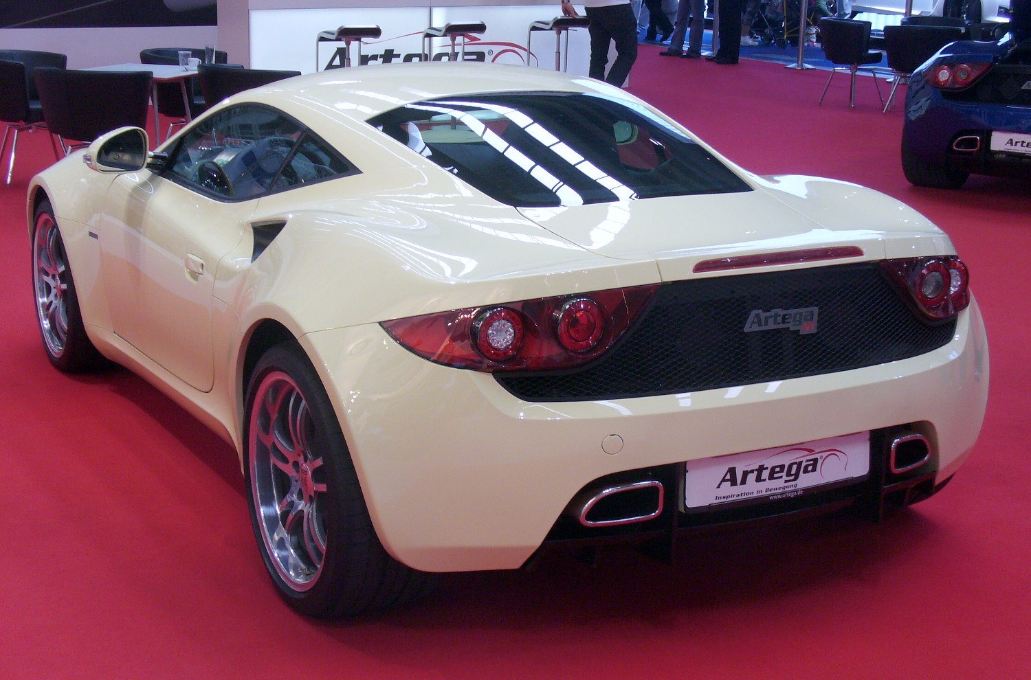 Sporty two-door coupe with distinctive dual round tail lights and integrated exhaust