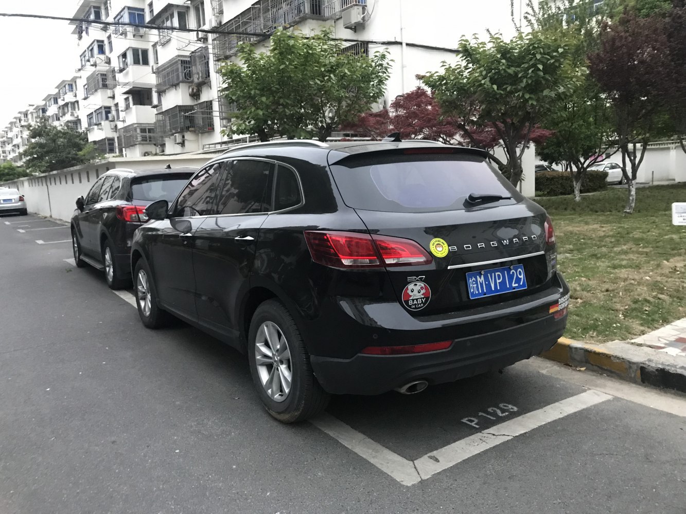 Rear view of an SUV with distinctive taillights and stickers