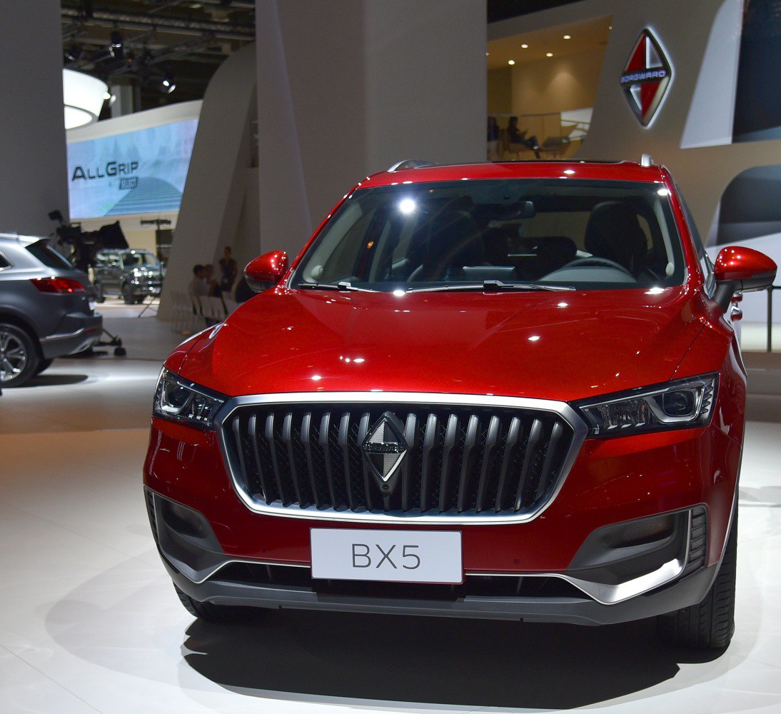 Front view featuring wide vertical grille and sharp LED headlights