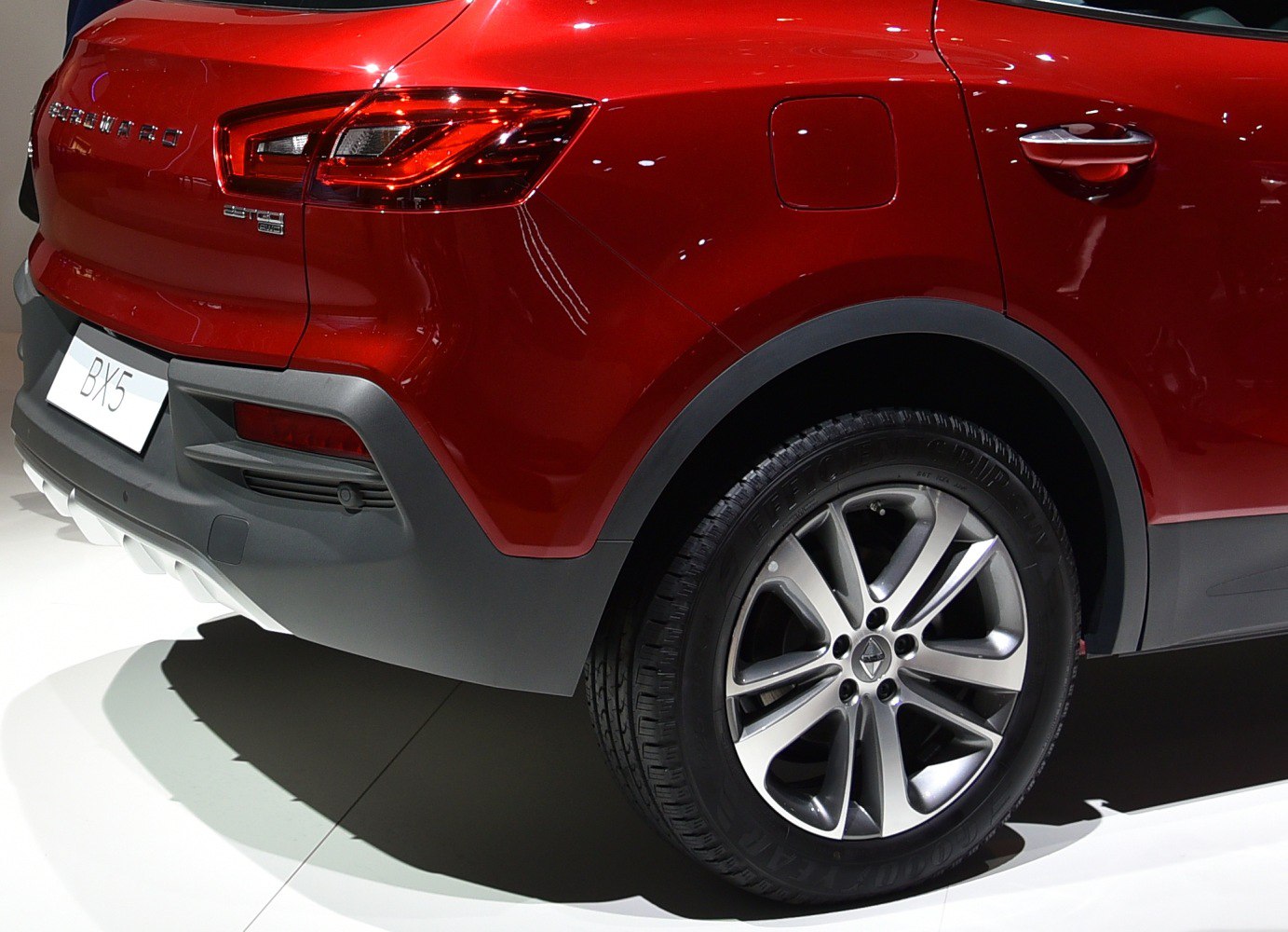 Close-up of rear taillight and alloy wheel on red SUV