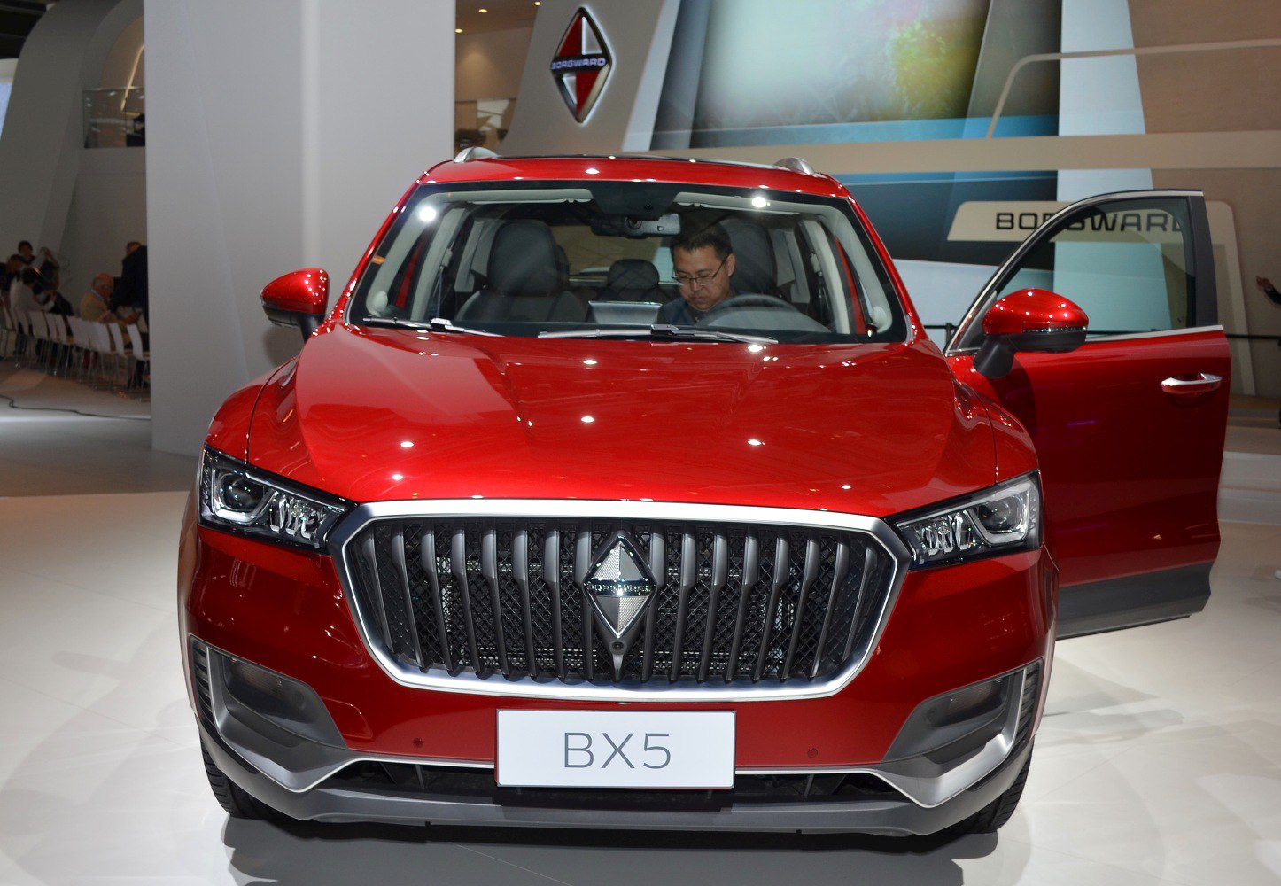 Red SUV front view with vertical grille and LED headlights