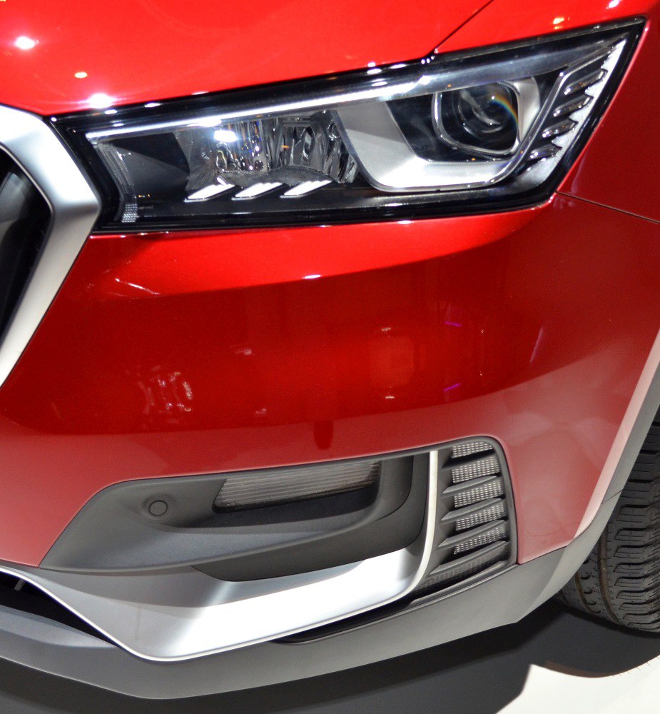 Close-up of front LED headlight and lower front grill