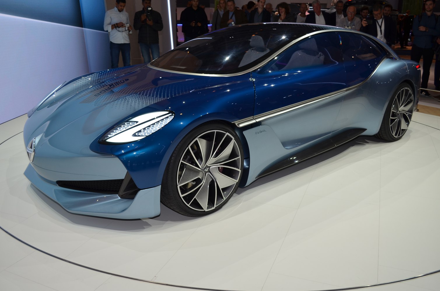 Futuristic blue two-tone sedan with aerodynamic styling and distinctive wheels