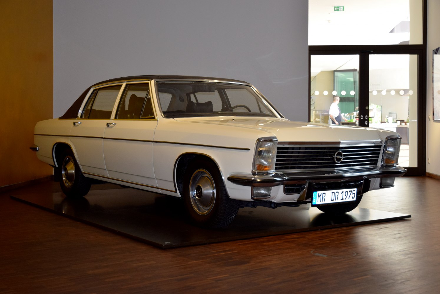 Front three-quarter view of a vintage sedan with rectangular headlights and chrome grille.