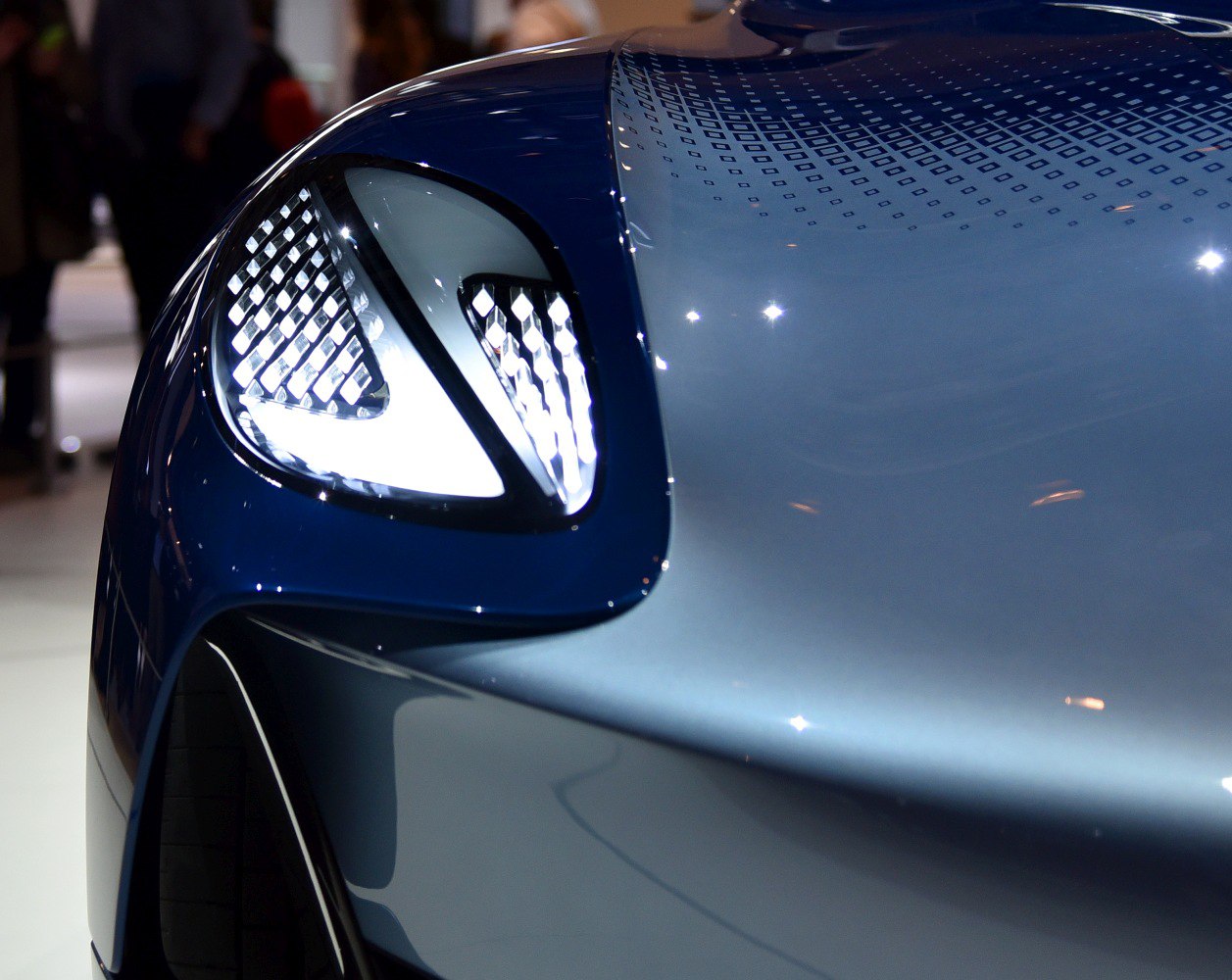 Close-up of LED headlight and detailed car hood