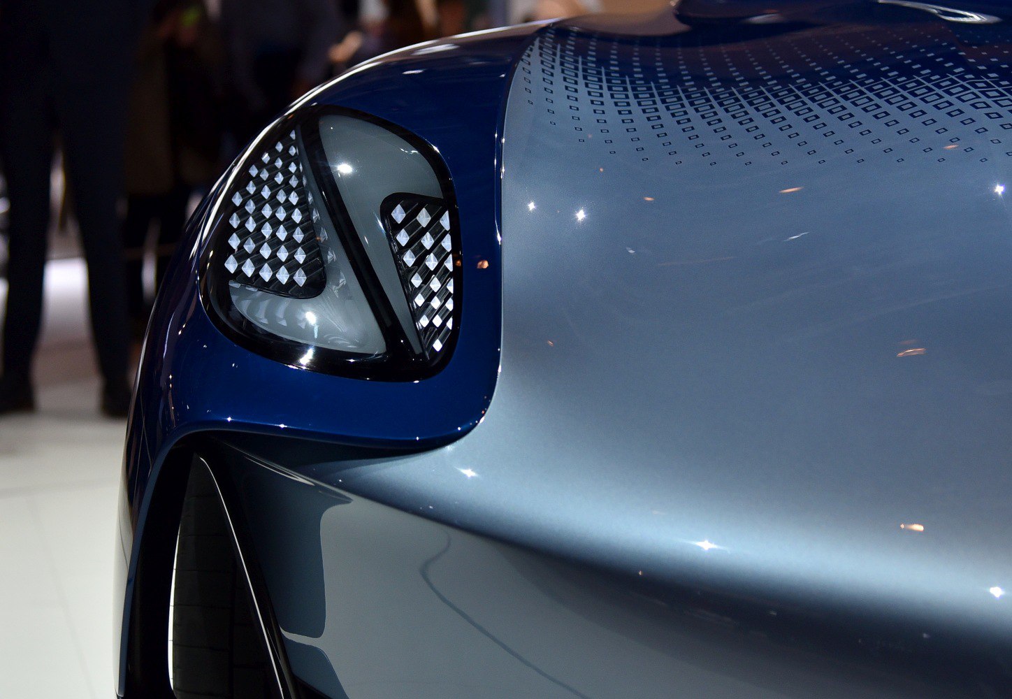 Futuristic headlight with diamond pattern and sleek hood design