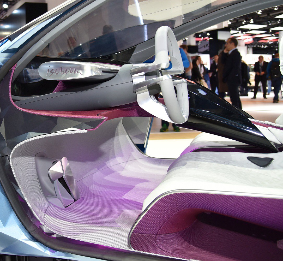 Futuristic steering wheel and ultra-modern car interior design in purple and white tones