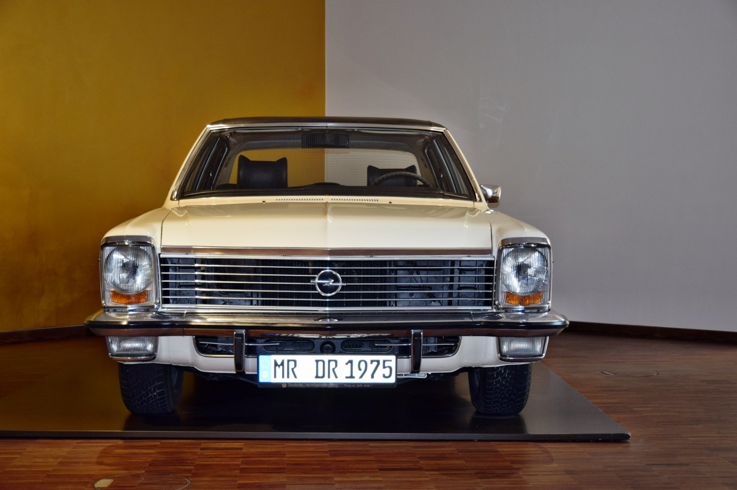 Front view of vintage sedan with wide chrome grille and rectangular headlights