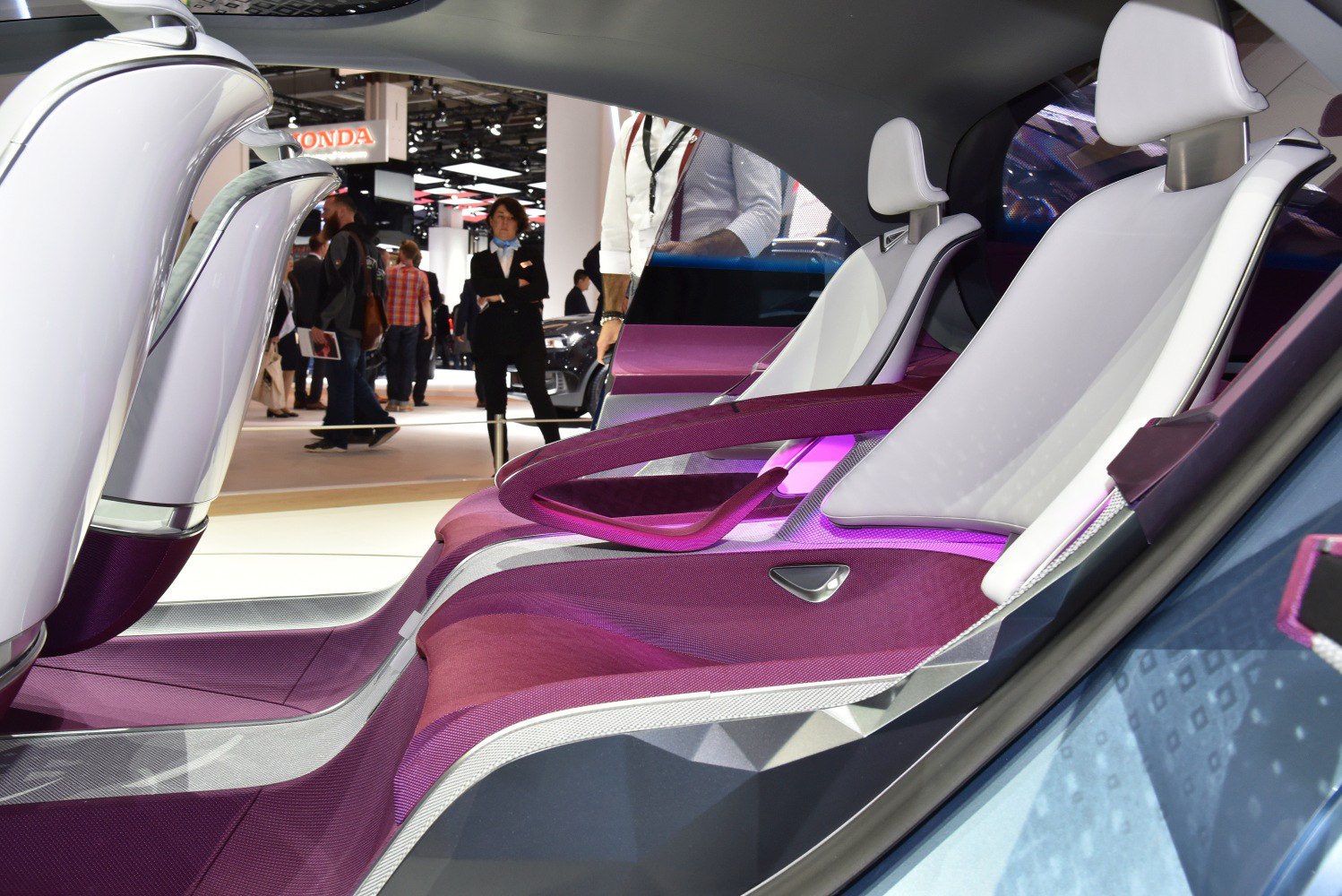 White ergonomic seats with futuristic design and illuminated armrests