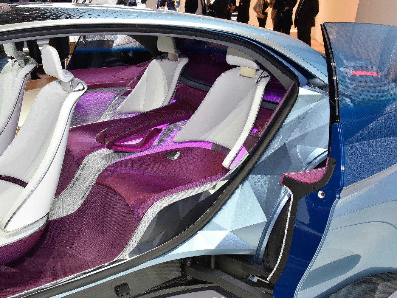 Futuristic car interior with purple ambient lighting and white seats