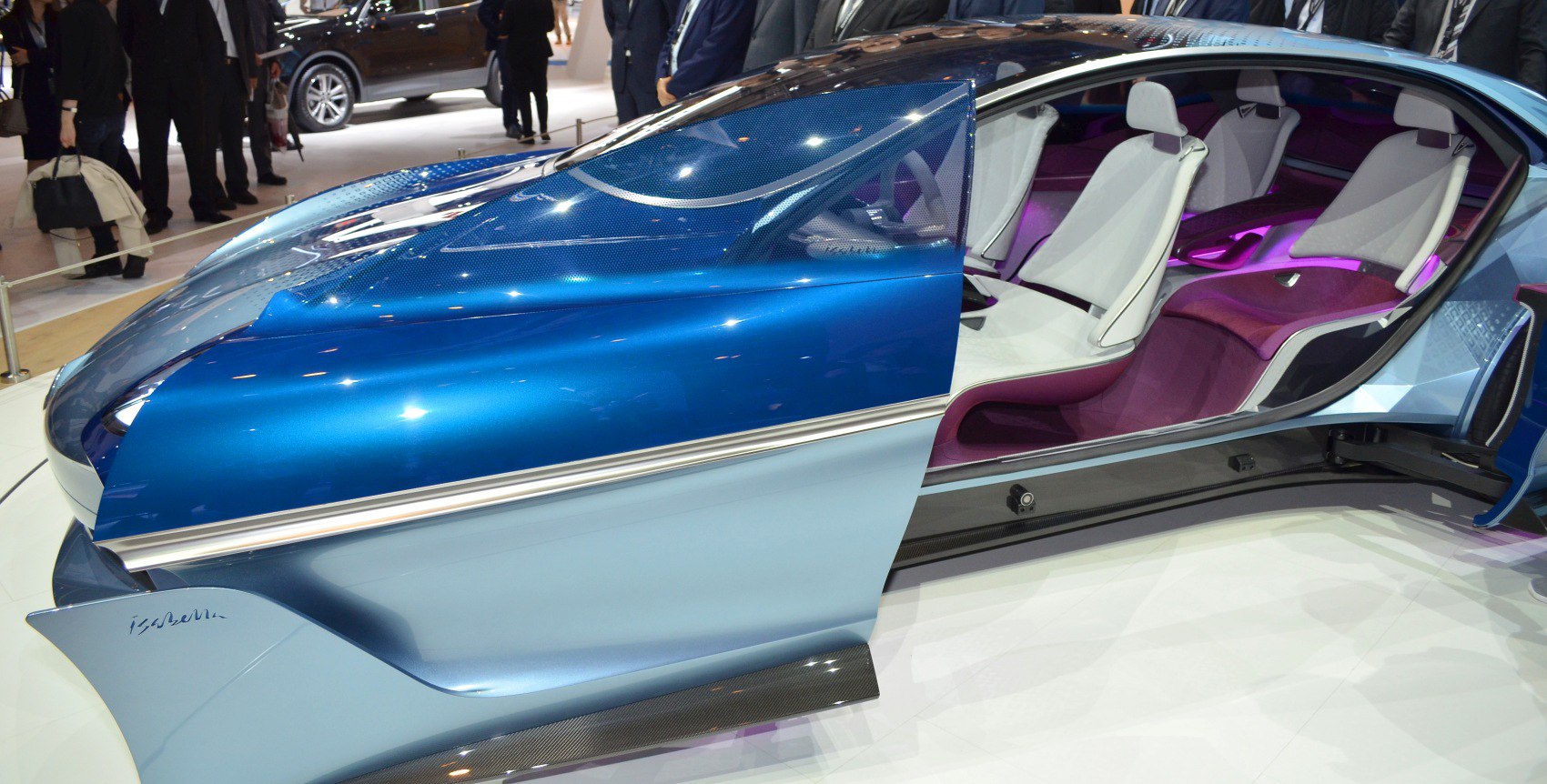 Futuristic blue side door with white seats and purple illuminated interior.