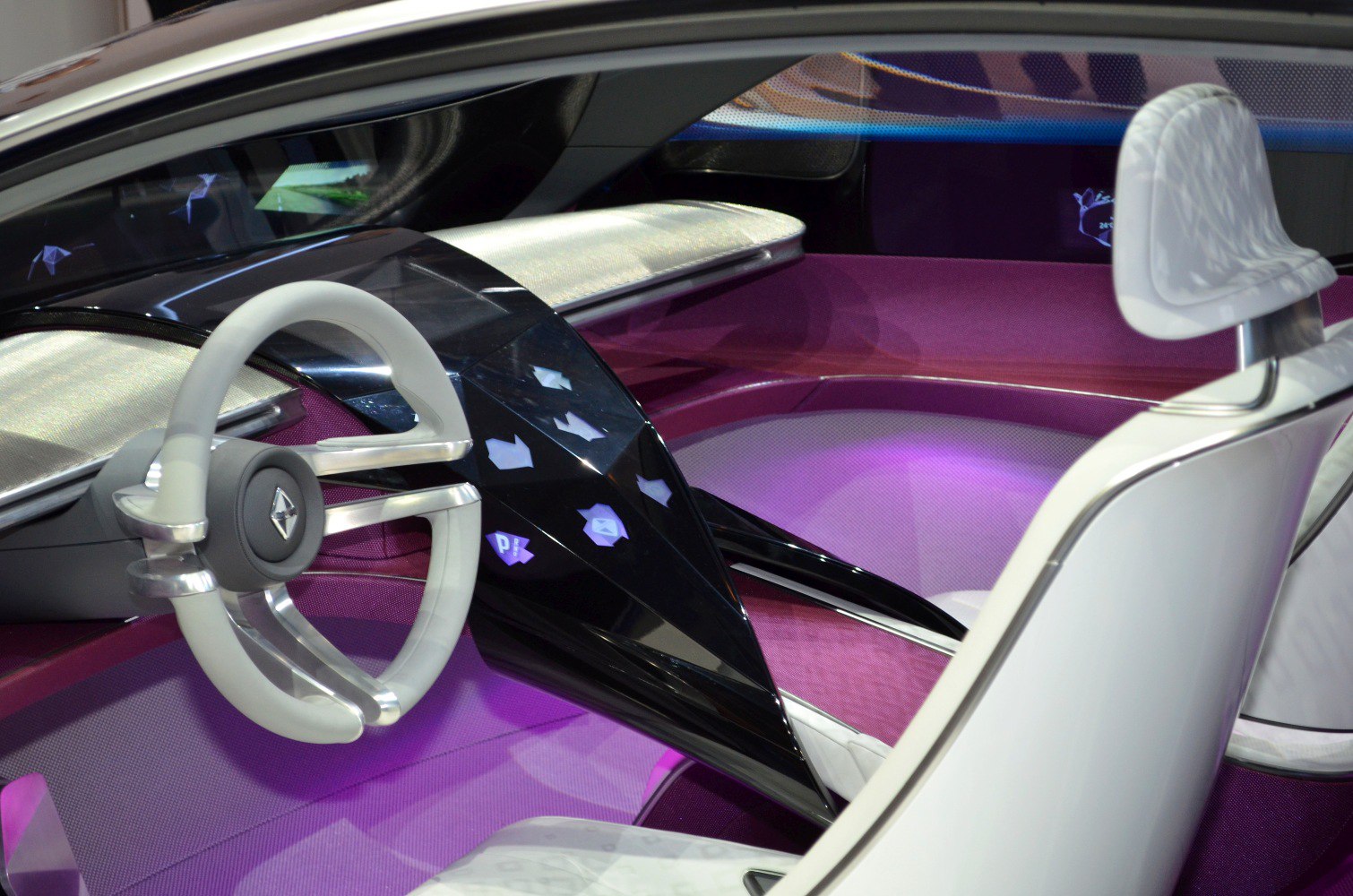 Futuristic dashboard and steering wheel inside a concept car.