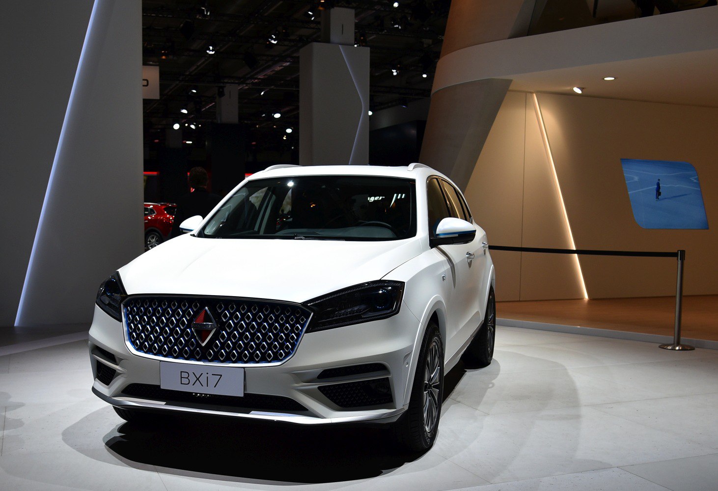 White luxury SUV front with diamond-pattern grille and LED headlights