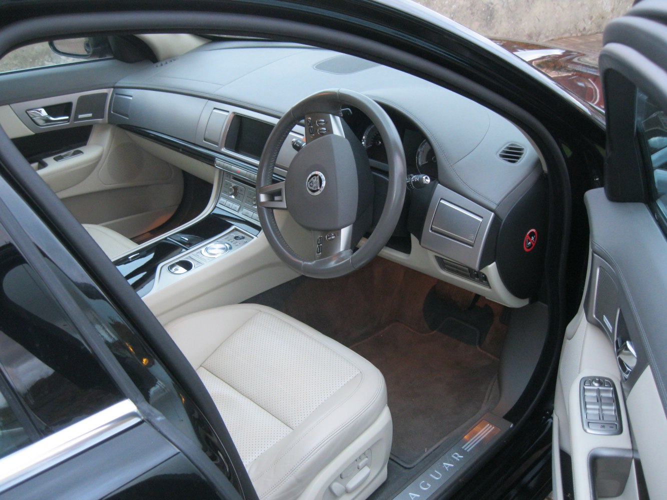 Luxury beige leather seats and dashboard with steering wheel and center console