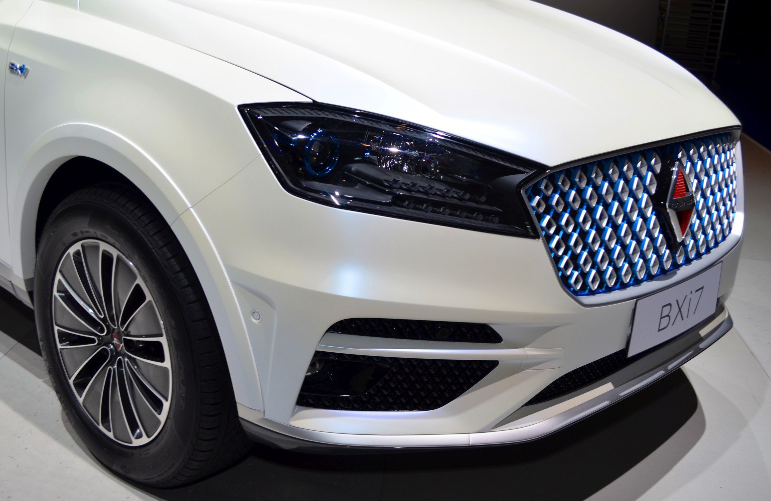 Close-up of modern front grille and complex headlight design