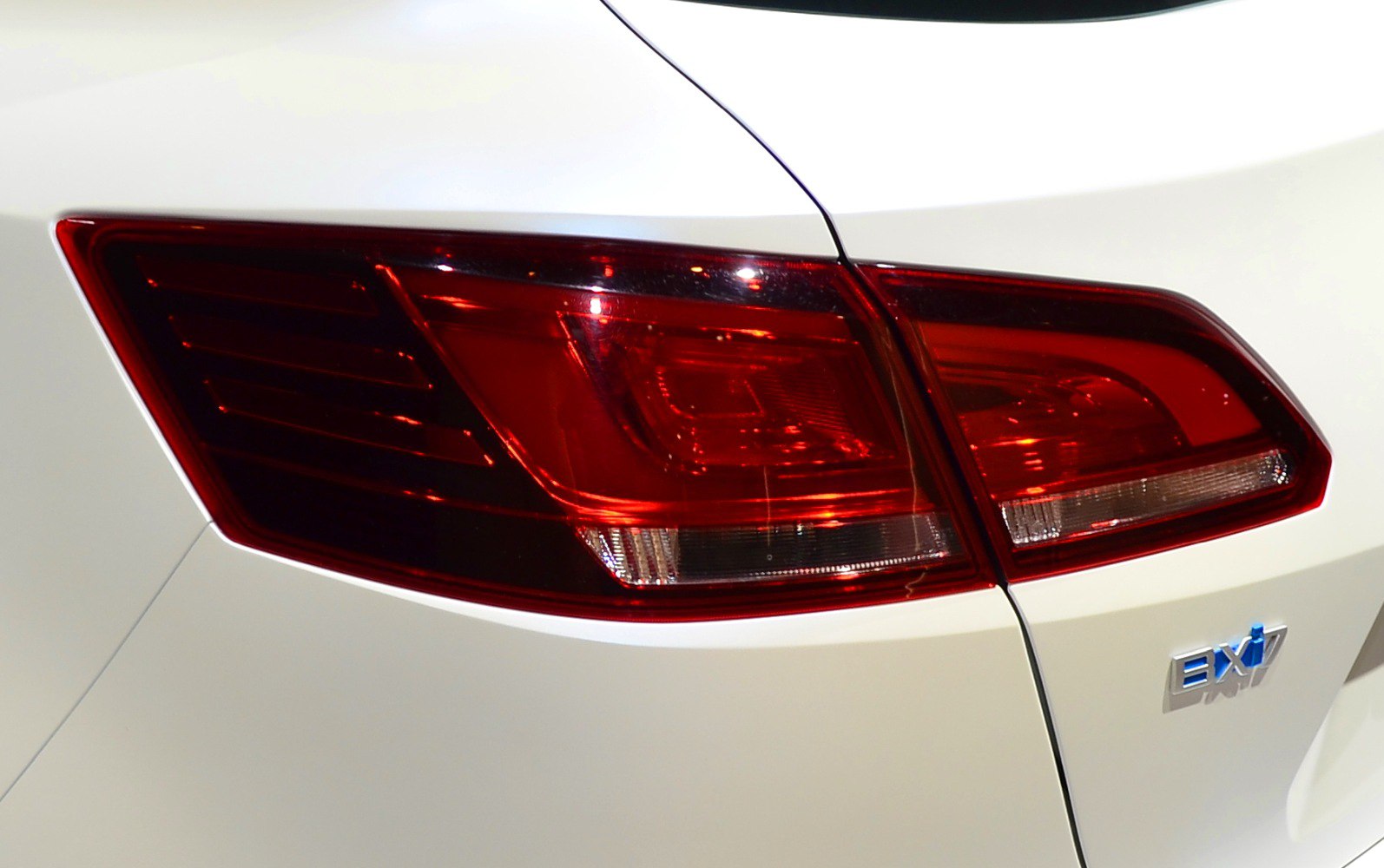 Close-up of a modern rear light cluster on a white vehicle.