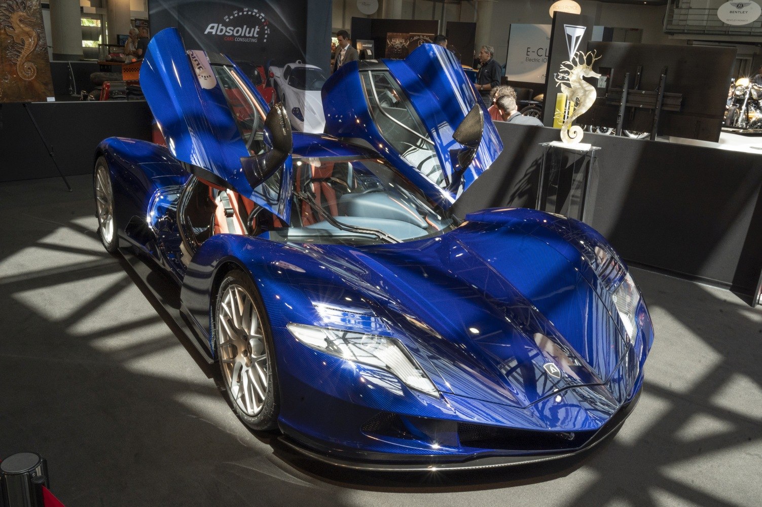 Electric hypercar with blue carbon fiber and butterfly doors