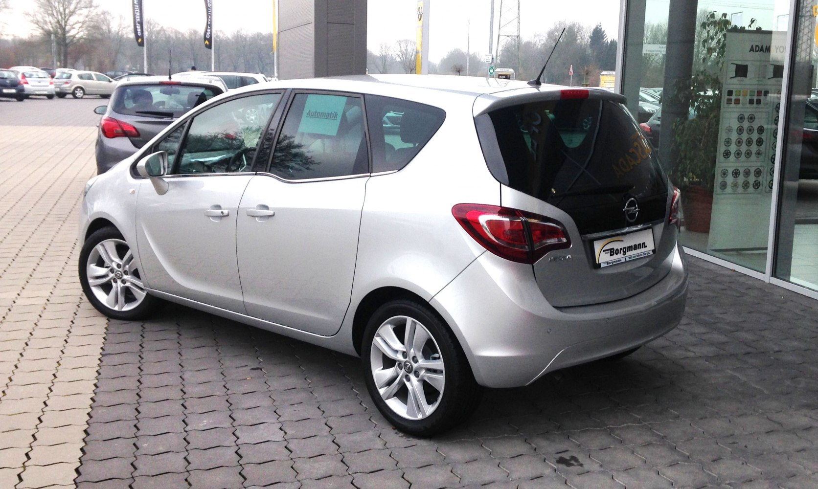 Silver compact hatchback rear and side view with distinctive taillights
