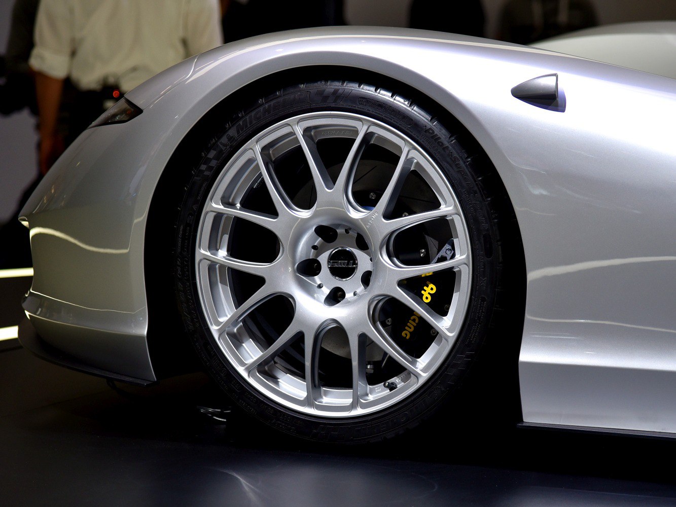 Silver multi-spoke alloy wheel with visible brake caliper