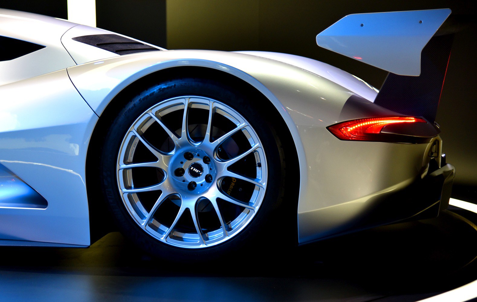 Rear wheel with multi-spoke alloy rim and large aerodynamic rear wing