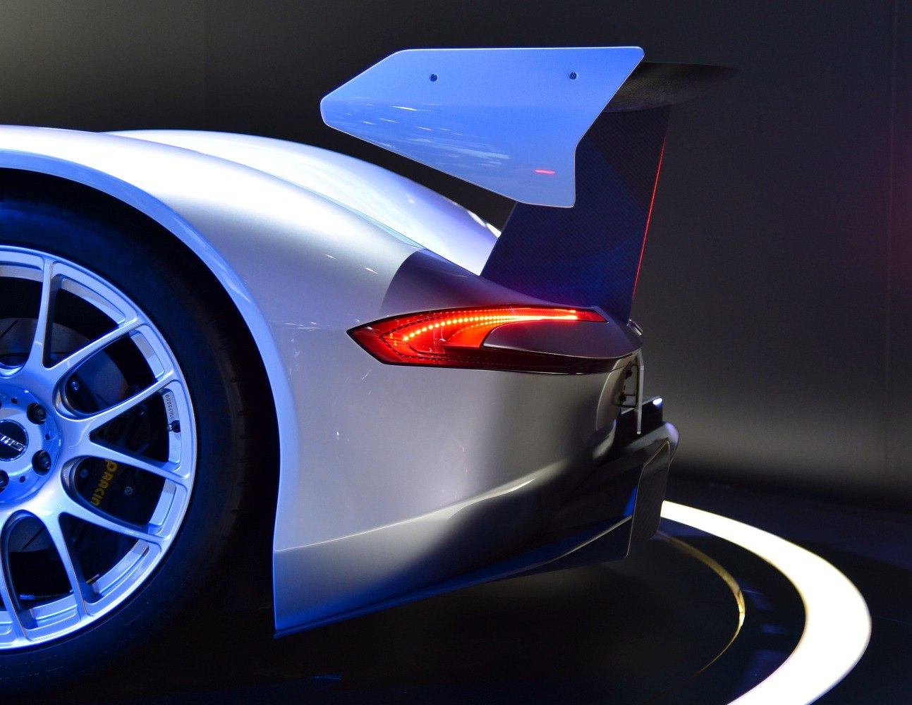 Close-up of rear wing, taillight, and wheel