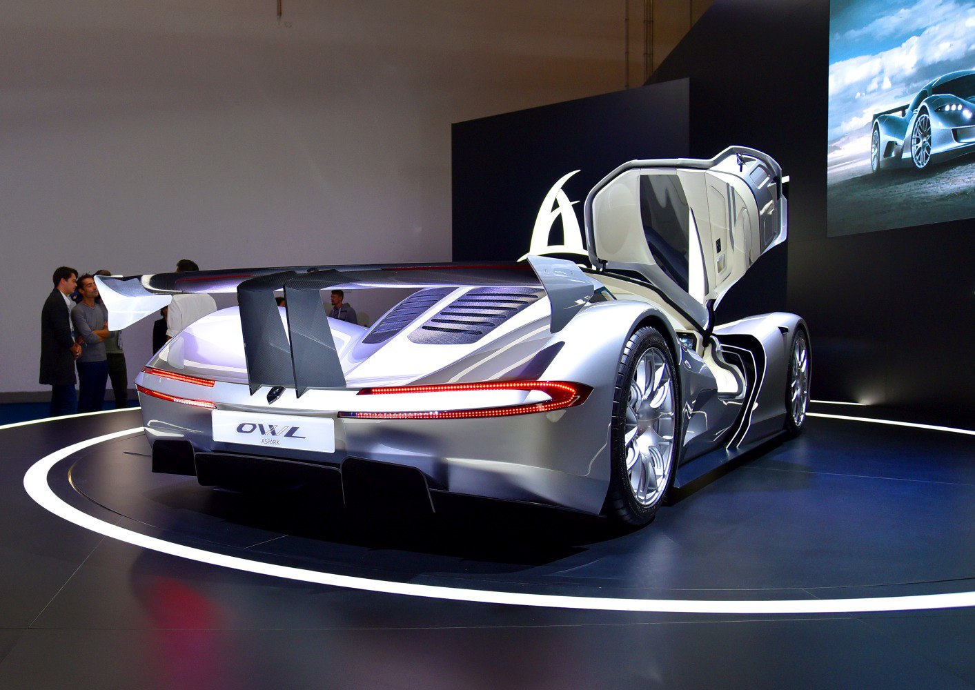 Hypercar rear view with raised rear wing and open gullwing door