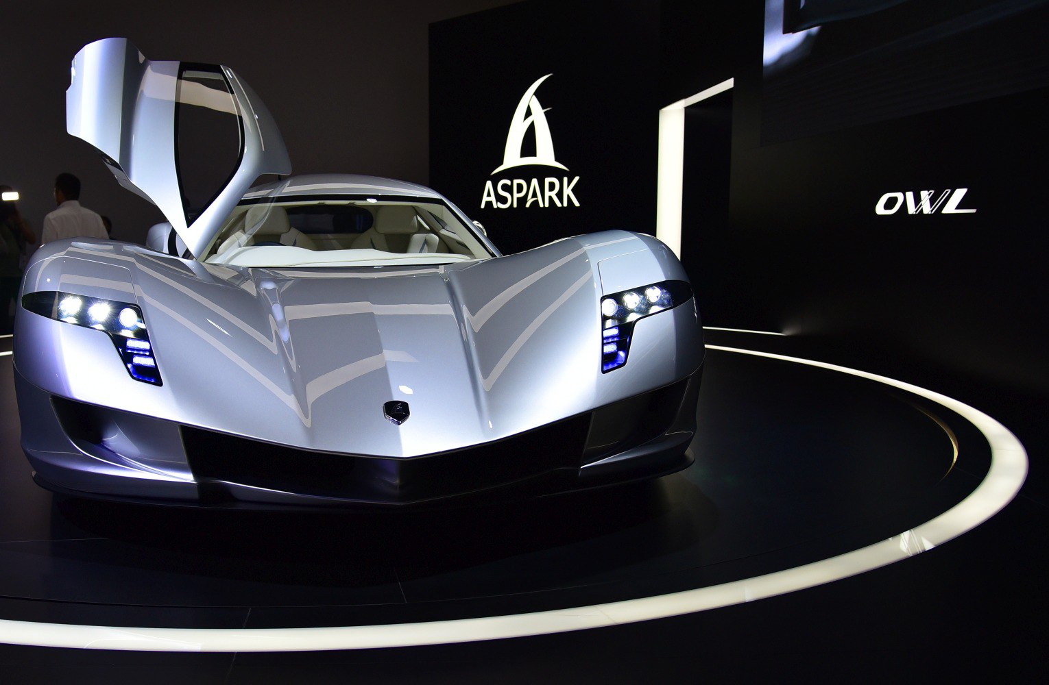 Silver hypercar with butterfly doors and LED headlights
