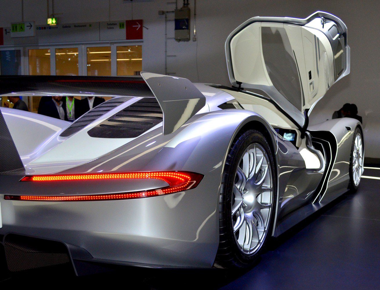 Electric hypercar rear with LED taillights and open gullwing door