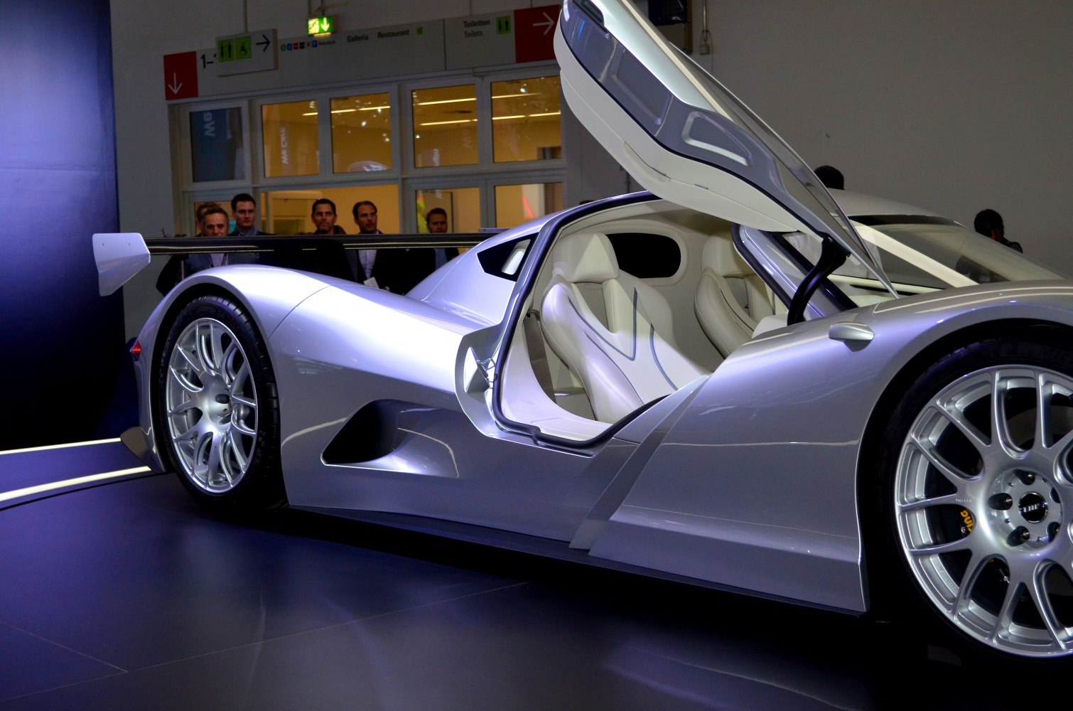 Side view of sports prototype with open scissor door and large rear wing