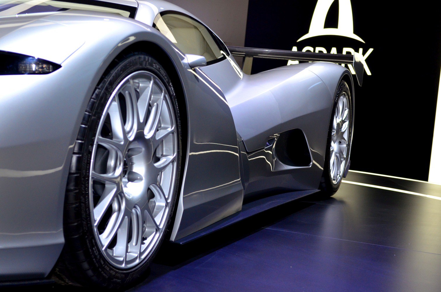 Aerodynamic sports car side panel with detailed multi-spoke alloy wheels