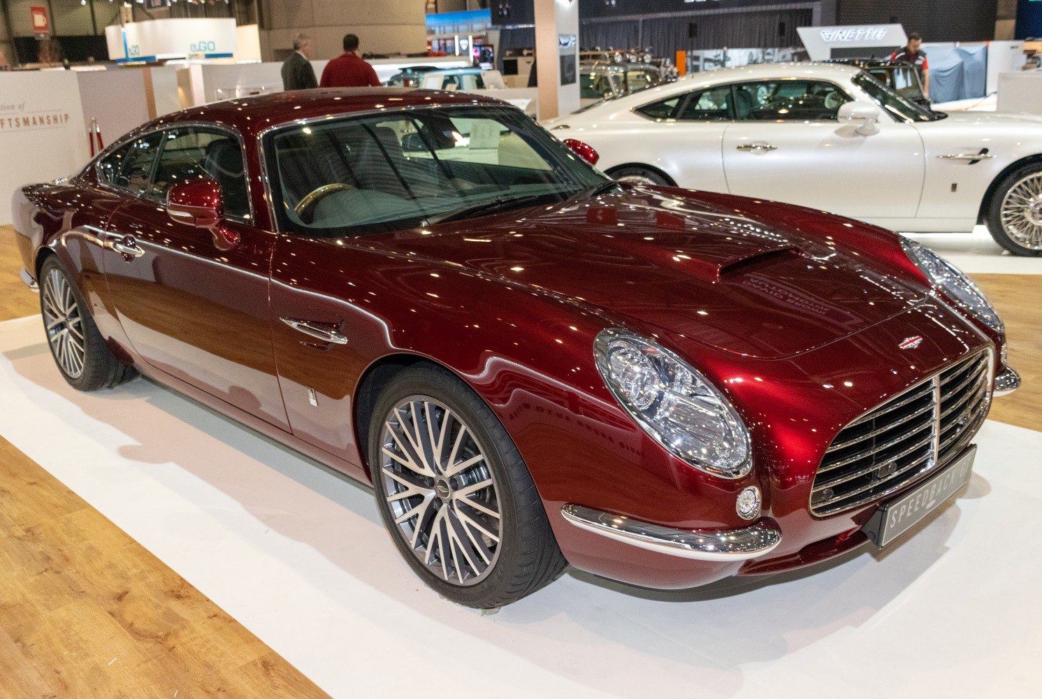 Elegant front grille and hood scoop of a vintage-inspired luxury sports coupe.