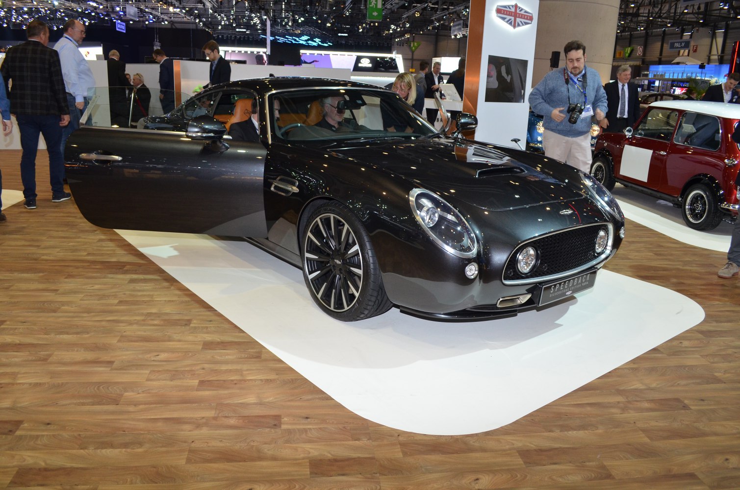 Front view of luxury coupe with open door and retro styling