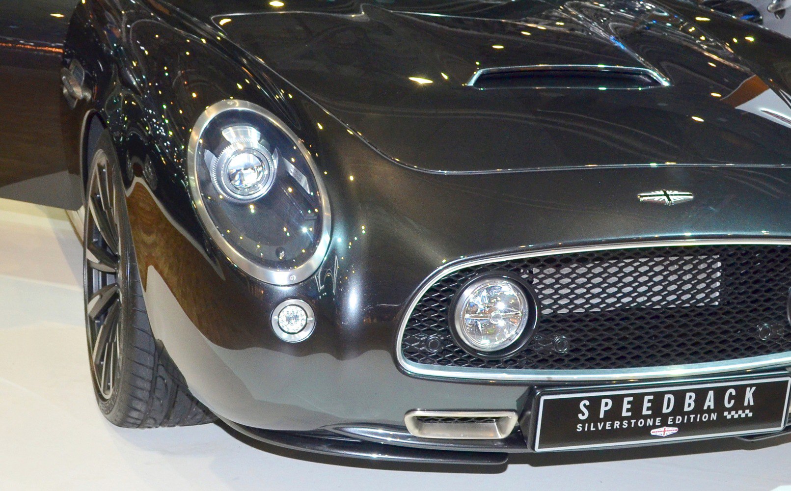 Close-up of front end with distinctive headlights and grille.