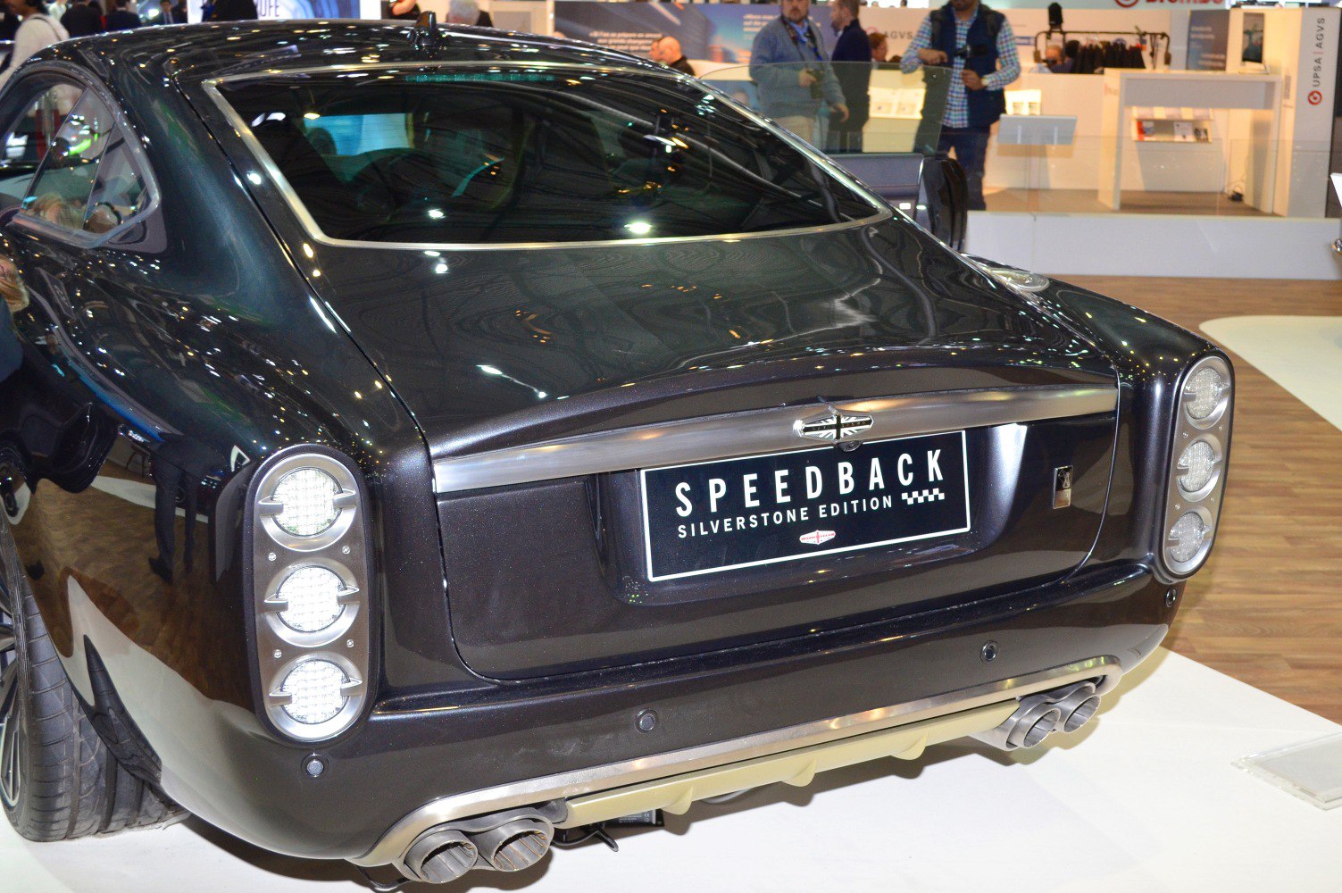 Rear view with round triple taillights and dual exhaust pipes