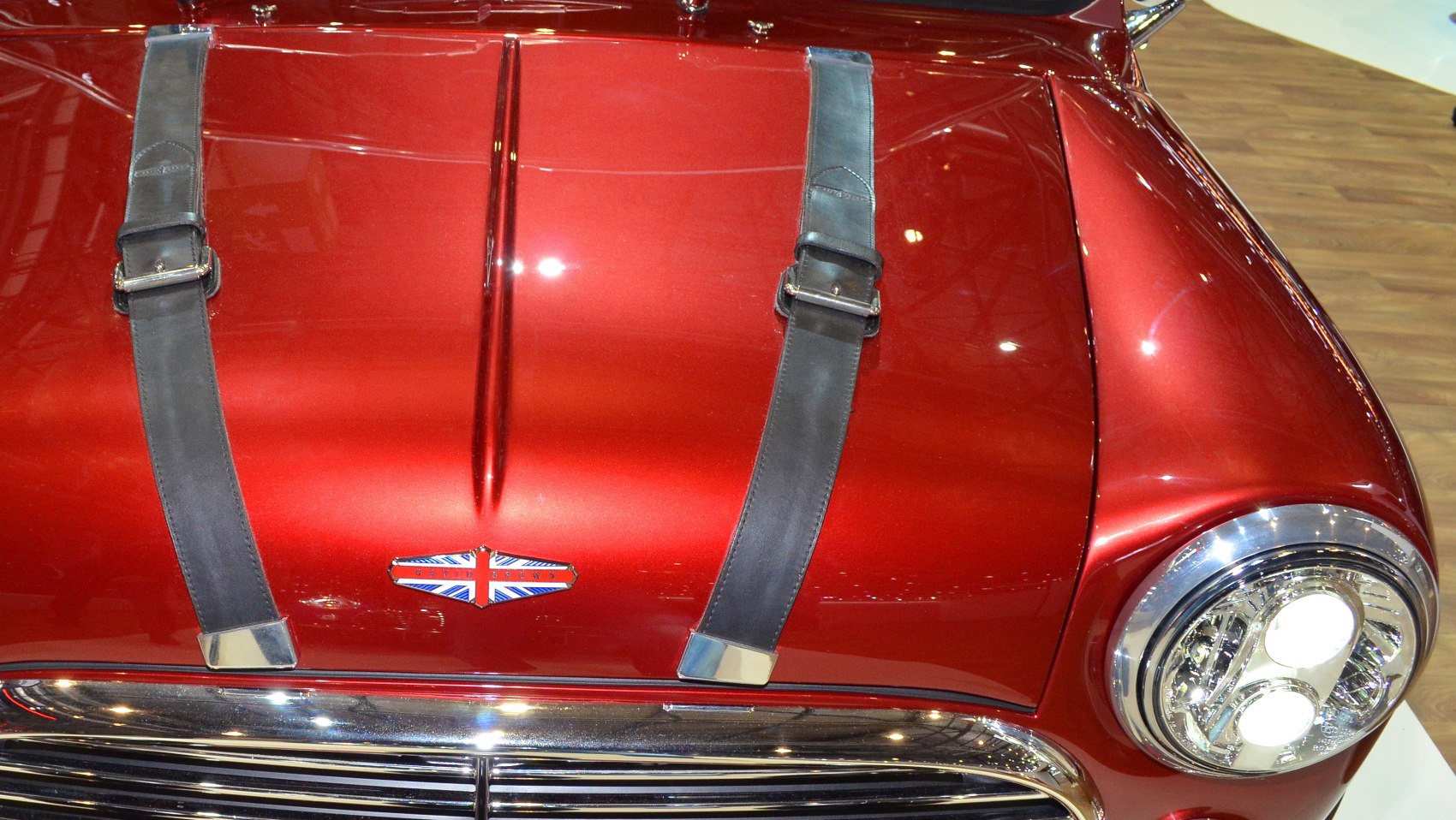 Close-up of a red hood with leather straps and a round headlight