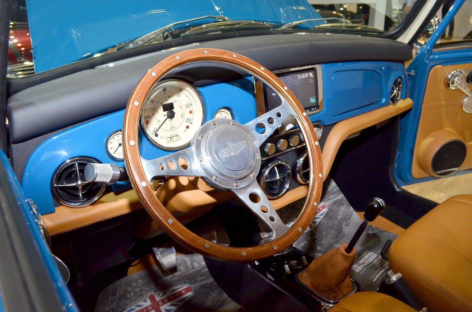 Wooden steering wheel and retro dashboard with gauges and manual gear lever