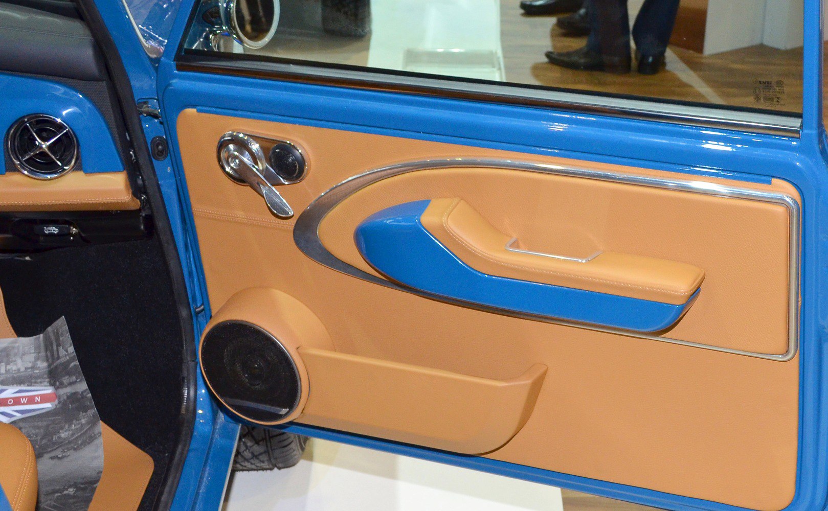Interior door panel with blue and tan trim and chrome handle
